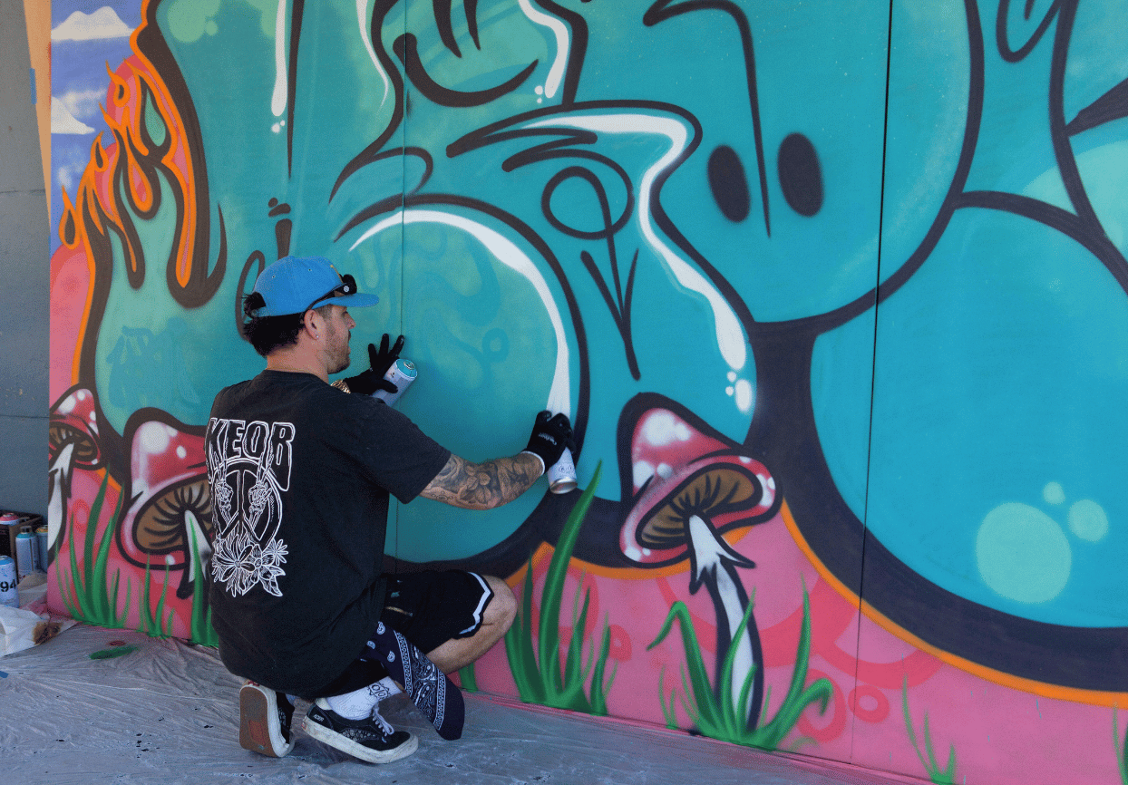 Artist KEOB painting a wall